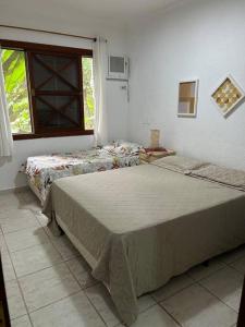 Postel nebo postele na pokoji v ubytování Casa em Condomínio Maresias frente a praia
