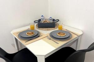 - une table avec des assiettes de nourriture et un panier de jus d'orange dans l'établissement La Petite Fleur - Centre ville, à Niort