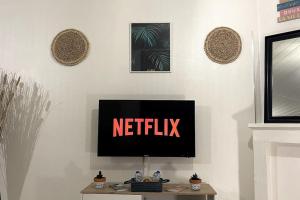 une télévision sur un mur avec les mots netflix dans l'établissement La Petite Fleur - Centre ville, à Niort 1 autre photo
