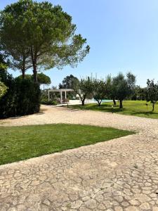 a path in a park with trees and grass at Villa Laura in Neviano