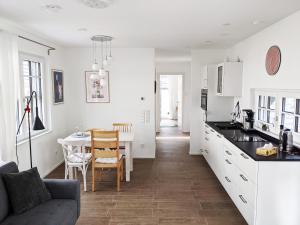 a kitchen and dining room with a couch and a table at Haus zur Aach Tinyhouse in Uhldingen-Mühlhofen