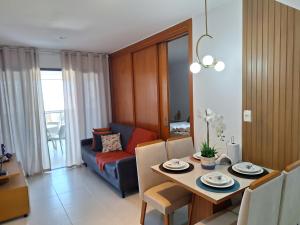 a living room with a table and a couch at Apto 19º andar, piscina, academia, garagem, ao lado do Shopping Salvador in Salvador