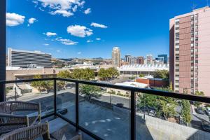 a balcony with a view of a city at City Views! Luxury King bed gym pool HTub in American Towers Condominium