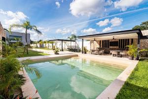a swimming pool in the backyard of a house at Departamento en Mérida en Privada con Amenidades in Xcanatún