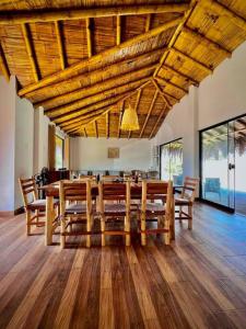 a dining room with a large wooden table and chairs at Hermosa Casa con Piscina y Playa Privada in San Martín