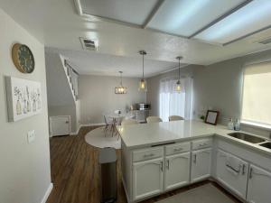 a kitchen with a sink and a counter top at Pristine & Smart freshly remodeled house! in Lancaster +40 photos