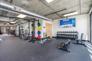 a gym with a lot of exercise equipment in it at City Views! Luxury King bed gym pool HTub in American Towers Condominium