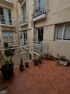 een balkon met potplanten voor een gebouw bij Carriles Inn in Mendoza +11 foto's