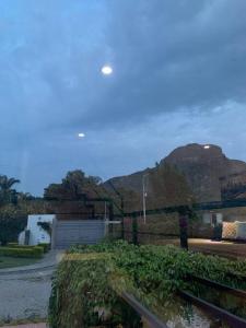 a field with a fence and a mountain in the background at Casa Carolina Loft Aryaz in Tepoztlán