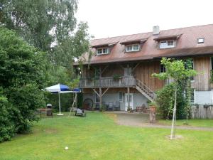 a large house with a deck and a yard at Alte Wassermühle in Salem
