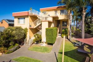 an apartment building with a balcony and a pathway at Baywatch 3 in Merimbula