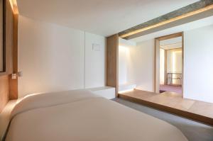 Postel nebo postele na pokoji v ubytování ADO hotel