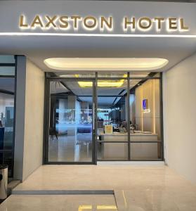 a lobby of a hotel with a sign on the door at Laxston Hotel in Yogyakarta