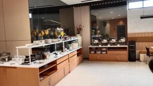 a kitchen with a lot of dishes on display at Laxston Hotel in Yogyakarta