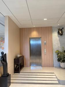a hallway with a door and a desk in a building at Laxston Hotel in Yogyakarta