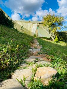 a stone path in the grass next to a building at ByB Casa campestre in Riochico Pérez