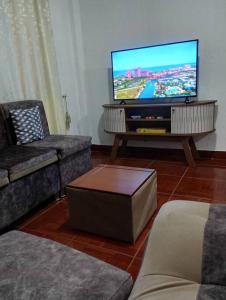 a living room with a flat screen tv at Departamento Acogedor en Ibarra in Ibarra