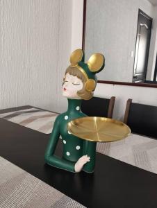 a toy doll with a plate on a table at Departamento Acogedor en Ibarra in Ibarra