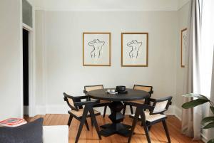 a dining room with a black table and chairs at Camelia Grove Hotel in Sydney