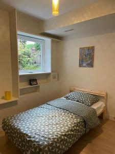 a bedroom with a bed and a window at Almost Home in West Vancouver