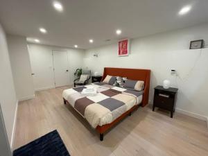 a bedroom with a large bed and a chair at Almost Home in West Vancouver