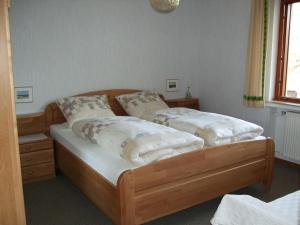 a bedroom with two beds with white pillows at Haus Mittelberg in Olsberg