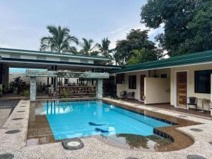 a swimming pool in front of a house at Midnite Inn in Panglao Island