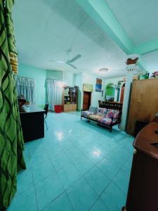 a living room with a couch and a table at Homestay Bendang Becah in Baling