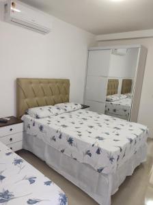 a bedroom with two beds and a mirror at Imbassaí in Imbassai +23 photos