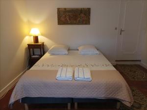 a bedroom with a bed with two towels on it at La maison au bord de l'eau in Graçay +34 photos