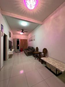 a living room with a couch and a table at Shamir Homestay in Lukut