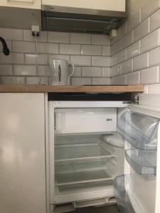 a kitchen with an empty refrigerator in a kitchen at Welch in Zaniemyśl