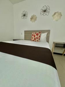 a bedroom with a large bed with flowers on the wall at 5th AVENUE oasis 8 personas in Playa del Carmen +28 photos