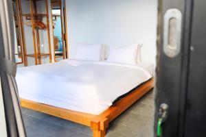 a bed with white sheets and pillows in a room at Peacock Private Pool Villa, self check-in, Workspace, Kitchen in Dalung +14 photos