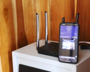 a cell phone is sitting on top of a table at Peacock Private Pool Villa, self check-in, Workspace, Kitchen in Dalung