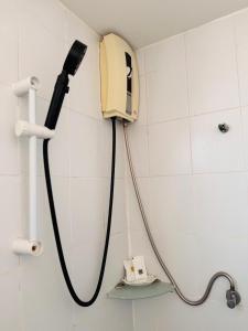 a phone hanging on a wall in a bathroom at Ocean Blue Huahin Guesthouse in Hua Hin +46 photos