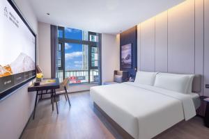 Rúm í herbergi á Atour Hotel Changsha Financial Center Chazishan Road