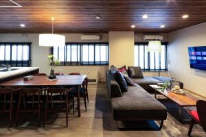 a living room with a couch and a table at The Villa Seaside in Abashiri