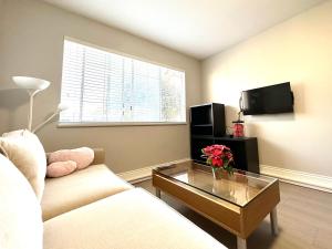 a living room with a couch and a coffee table at Newly renovated 2 bed 1 bath in Ladner BC in Delta