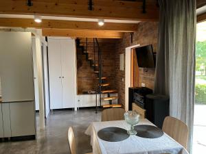 a dining room with a table and a staircase at U Marty - Agroturystyka in Rogawka +7 photos