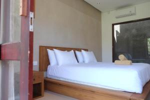 Postel nebo postele na pokoji v ubytování Dipenida Bali
