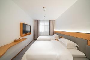 Postel nebo postele na pokoji v ubytování Denpa Inn - Shanghai Hongqiao Jinhui Road Branch
