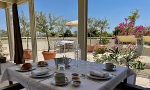a table with plates of food on top of a patio at Palazzo Pitagora in Taranto