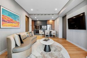 a living room with a couch and a table at Forbes Manaa Living in Perth