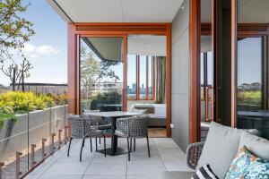 a patio with a table and chairs on a balcony at Forbes Manaa Living in Perth