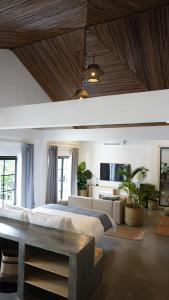 a large bedroom with a large bed and a couch at Bliss Villa by Happiness Philippines in El Nido