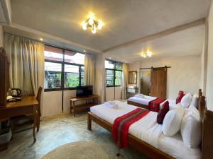 a bedroom with two beds and a desk and a desk at Mesa Garden Villa in Chiang Mai +52 photos