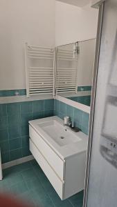 a bathroom with a white sink and a mirror at I due Ulivi Cornino in Custonaci