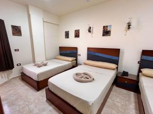 Postel nebo postele na pokoji v ubytování Reef House + 37 fotografií