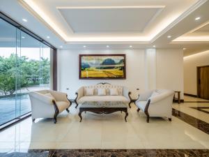 a living room with a couch and two chairs at Nui Vang Trang An Hotel Ninh Binh in Ninh Binh